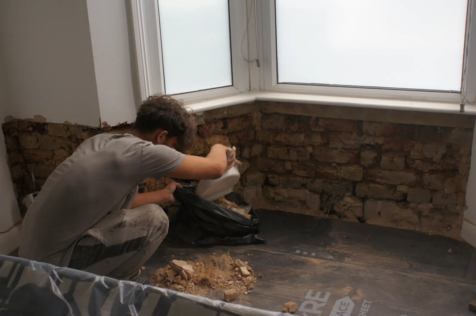 Bay window walls stripped back to brick during a damp investigation