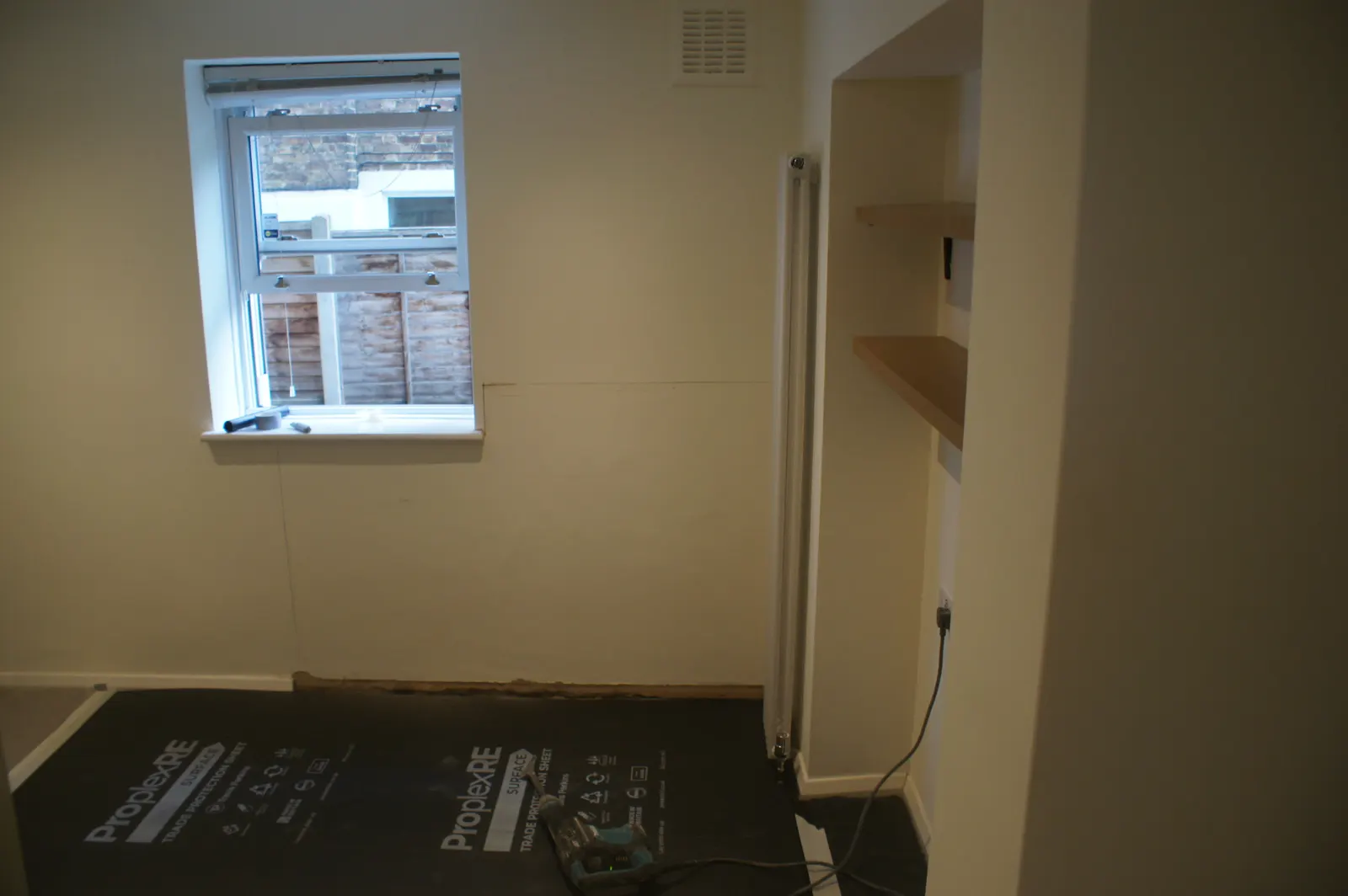 Furnishings and floors covered with protective sheeting during damp proofing