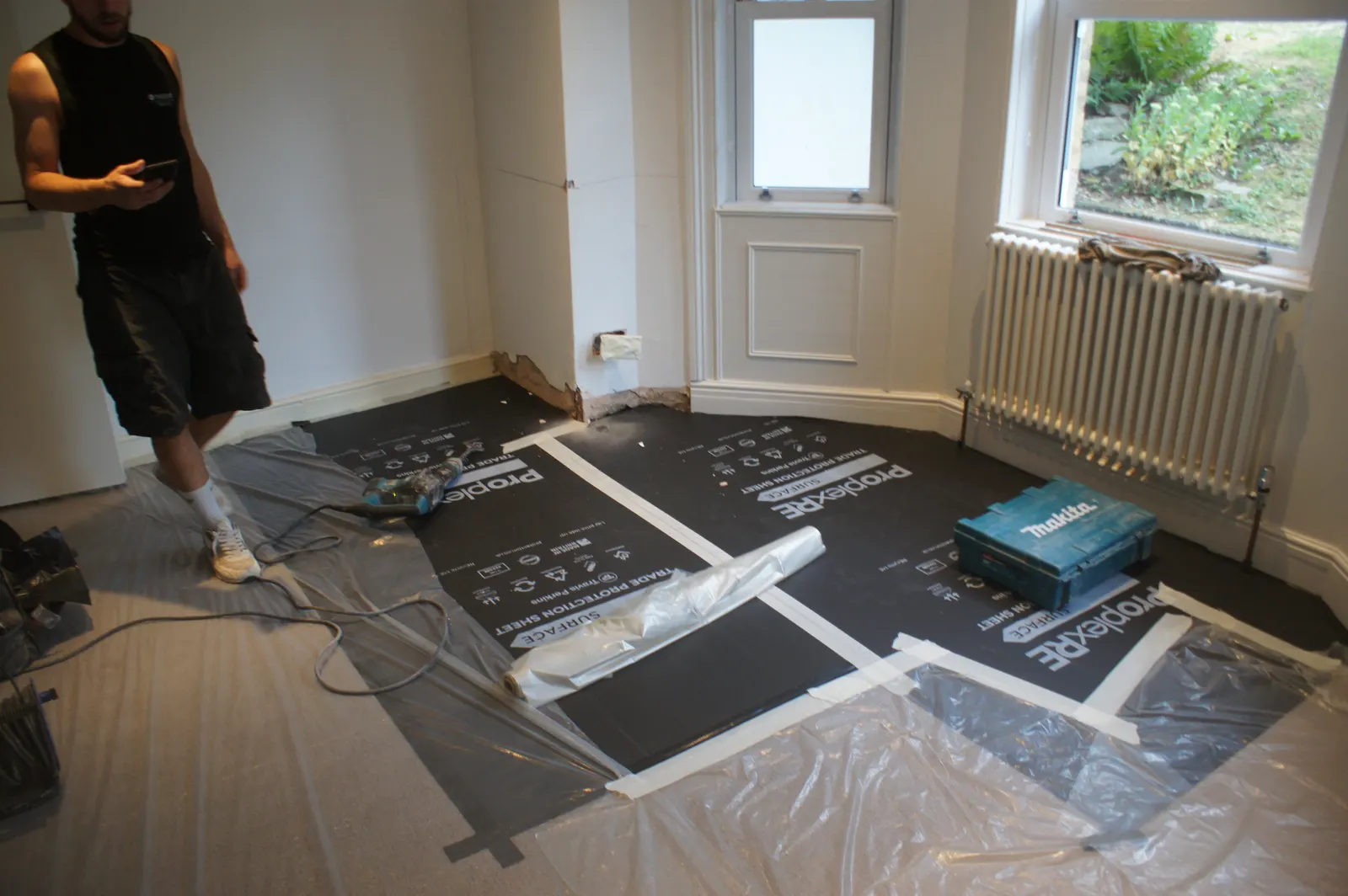 Room with floors fully sheeted and protected before remedial work