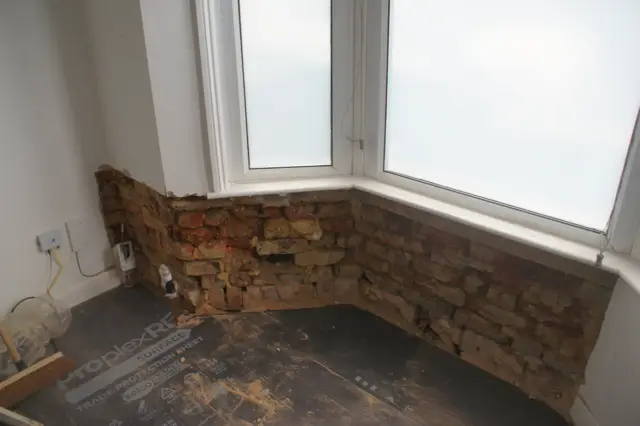 Exposed bay brickwork ready for treatment
