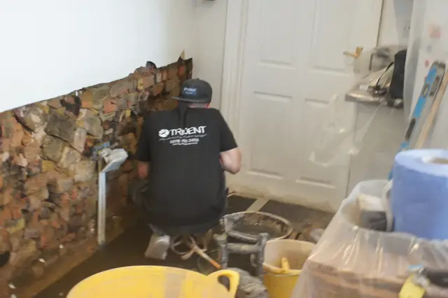 Old plaster off, brickwork ready for a new DPC