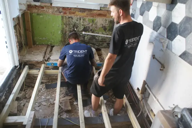 The team renewing a rot-damaged kitchen floor