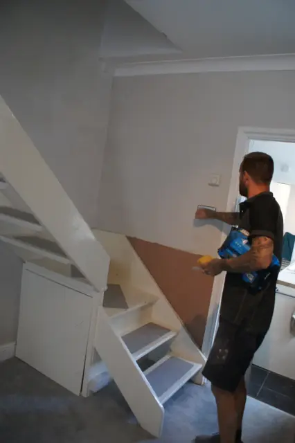 Finishing touches under the stairs