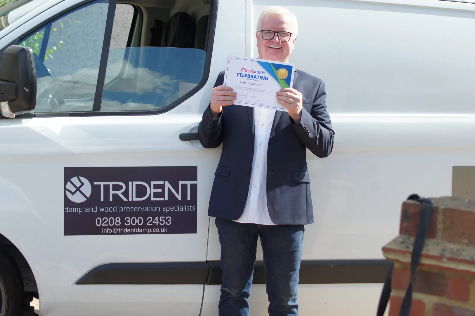 Joseph O'Regan, founder of Trident Damp, with the sign-written company van