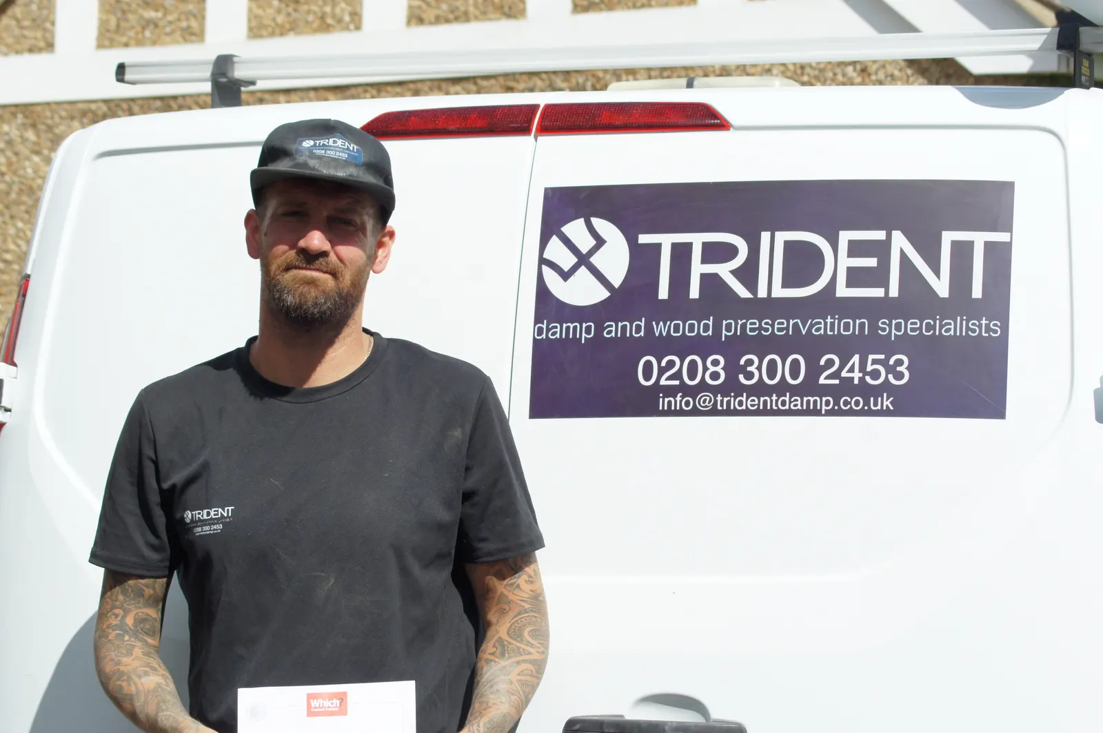 Robert, Manager at Trident Damp, in company workwear by the van